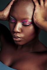 Poster - Why fit in when you were born to stand out. Cropped shot of a beautiful woman wearing colorful eyeshadow while posing against a grey background.