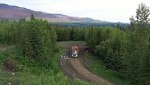 Logging Truck In Forest: Aerial View Of Timber Transport In British Columbia