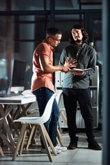 Canvas Print - Hes giving me some really cool ideas. Shot of two businessmen discussing in a notebook while working late.