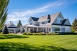 © 2rogan - Gorgeous, recently-built house exterior featuring a spacious three-car garage and a lush, green lawn illuminated by the sun on a clear day, adorned with a vibrant blue sky and scattered white clouds.