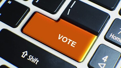 Laptop Keyboard Close Up and Finger Press Vote Word or Text Button Key.