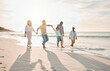 © Daniels C/peopleimages.com - Holding hands, swing and big family at the beach walking with freedom, travel and bonding at sunset. Love, lifting and and boy child with grandparents and parents at sea on walk for summer holiday