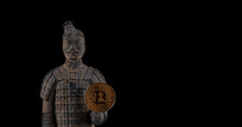 A Coin With The Symbol Of The Cryptocurrency Bitcoin And A Warrior From The Terracotta Army Of The Chinese Emperor Qin Shi Huang