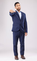 Wall Mural - Thumbs down, disappointed and portrait of business man in studio with upset, unhappy and negative gesture. Emoji, professional and male person with hand gesture for bad review on white background