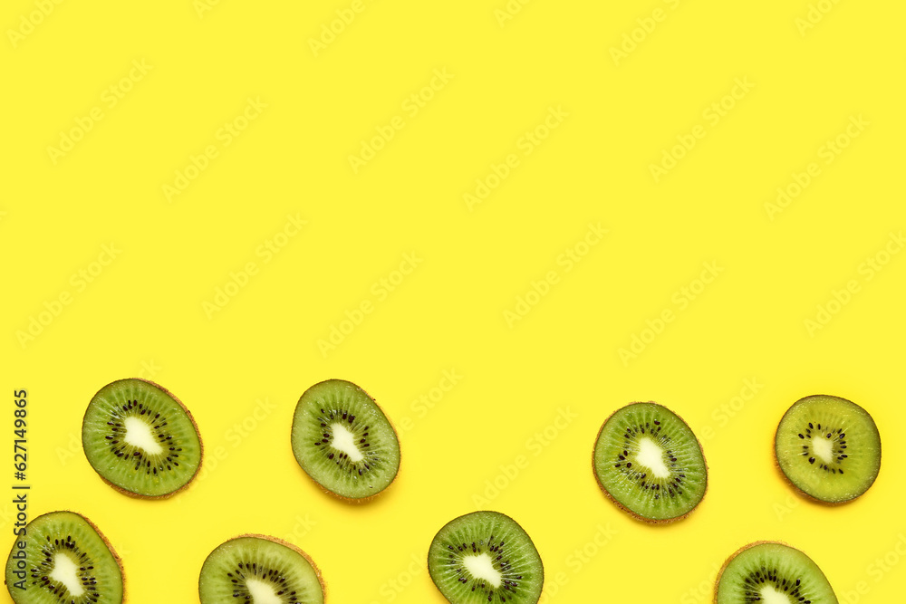 Slices of fresh kiwi on yellow background