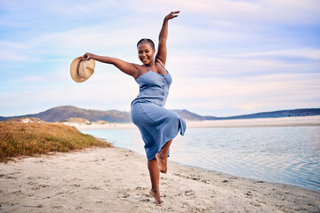 Portrait, excited and black woman dancing, beach and movement with happiness, tropical island or sunset. Face, female person or girl outdoor, travel or seaside holiday for stress relief, dance or joy