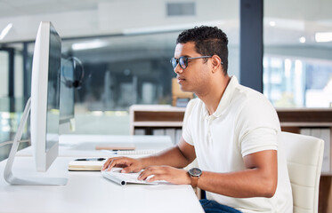 Computer, IT and man developer typing or coding in an office working on a project online, web or internet. Website, search and professional person or programmer at an agency or startup using a pc