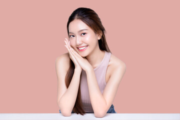 Beautiful young Asian woman with healthy and perfect skin on isolated pink background. Facial and skin care concept for commercial advertising.