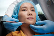 © DragonImages - Doctor marking areas on face of patient before facelift surgery