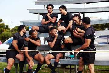 Poster - Action isnt just reserved for the field. Shot of a group of young men sitting on the benches together at a rugby game.