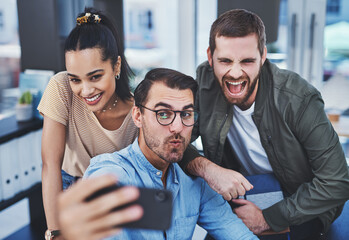 Poster - never a dull moment when this dynamic team are together. shot of a group of designers taking selfies
