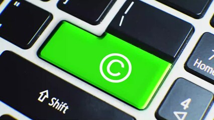 Laptop Keyboard Close Up and Finger Press Copyright Symbol Button Key