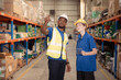 © Wosunan - Portrait of confident male supervisor and female staff working together in warehouse with digital tablet