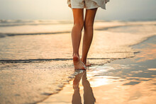 Closeup Of Woman Feet Walking On Sand Beach During A Golden Hour Sunset. Travel And Relaxing In Summer	