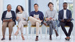 © Ismail/peopleimages.com - Diversity, portrait of businesspeople sitting and happy waiting in a office at their workplace. Multicultural or corporate, collaboration and smiling colleagues sit on chairs in a boardroom at work
