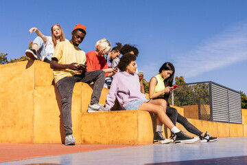 Wall Mural - Multiracial group of young friends bonding outdoors