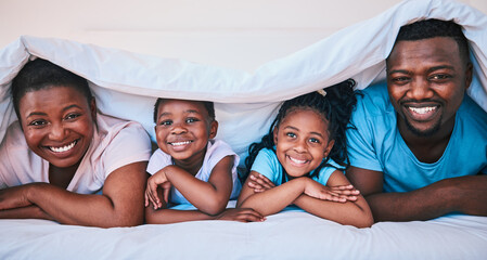 Wall Mural - Smile, black family and portrait in a bed with blanket, relax and comfort on the weekend in their home. Happy, face and children with parents in bedroom playing, cover and rest, fun and cheerful