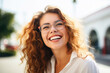 © Jasmina - Portrait of happy young woman wearing glasses outdoors