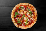 Fototapeta  - Pizza with chicken fillet, bacon, sausages, chili pepper, onion and greens
