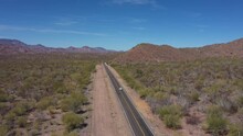 Small Car Driving Along Highway In Mexican Desert Area. Aerial Drone View