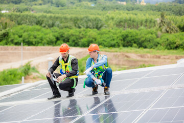 Wall Mural - Professional specialist technician engineer working to maintenance checking and installing solar roof panel on the factory rooftop under sunlight. Worker inspection team for smart grid ecology energy