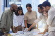 © CineLens/peopleimages.com - Business people, team and discussion of paperwork at table in office for planning project, collaboration and ideas in startup. Group, diversity and employees meeting for brainstorming with documents
