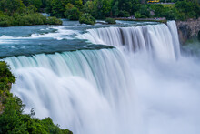 A Long Exposure Photo Of The American - Canadian Waterfalls Niagara Falls In The Evening.