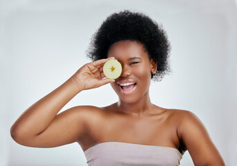 Happy black woman, portrait and apple for diet, natural nutrition or health against a white studio background. Face of African female person smile with organic fruit for fiber, vitamins or body care