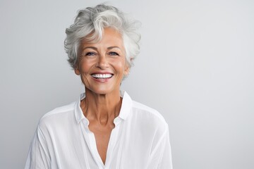 beautiful gorgeous 50s mid age beautiful elderly senior model woman with grey hair laughing and smil