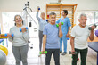 © Robert Kneschke - Therapists assisting elderly people exercising at rehab center