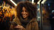 © AS Photo Family - Smiling african american woman using smartphone in city at night.