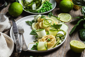 Wall Mural - Pasta with zucchini and green peas in a bowl