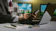 © boonyawat - businessman  using smart phone with laptop and digital computer and document on desk in modern office with virtual interface graphic icons network diagram