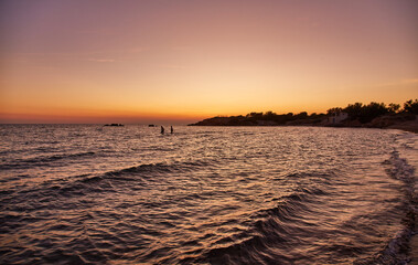 Wall Mural - Beautiful sunrise over water on the beach of Torre Dell'Orso. Salento coast. Italy, Puglia. Bright sea sunrise.