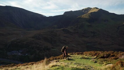 Wall Mural - A backpacker stopping in the Welsh mountains to admire the view