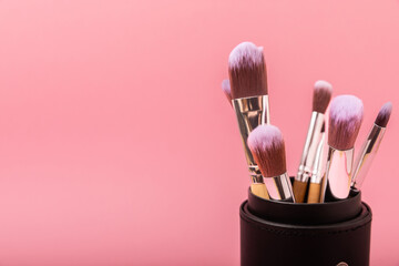 Sticker - Cosmetic makeup brush on a pink background. Cosmetic product for make-up. Creative and beauty fashion concept. Fashion. Collection of cosmetic makeup brushes, top view, banner.Place for text. MOCAP.