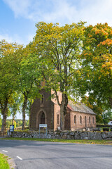 Canvas Print - Old country church in autumn colors by a road