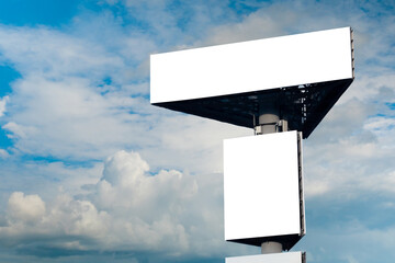 Wall Mural - mock up - two blank white billboards or large advertising displays against blue sky with white cloud