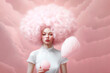 Beautiful woman with stick yummy cotton candy on pink background