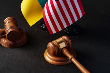 Wall Mural - Two judge's gavels with USA flag and flag of Ukraine on black background