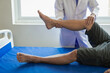 © MrAshi - Rehabilitation therapy Professional male physiotherapists working in rehabilitation centers while treating male patients with leg and muscle pain.