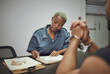 © Mumtaaz Dharsey/peopleimages.com - Crime, prisoner and woman police officer at the station writing a legal report for social justice. Law enforcement, security and male thief in handcuffs talking to female guard in interrogation room.