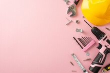 Embracing The Significance Of Women's Contributions On Labor Day. Overhead Image Showcasing A Yellow Helmet And Construction Tools On A Pink Isolated Background, With Copy-space For Text Or Ads