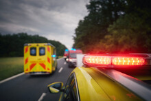 Ambulance Cars And Fire Department Vehicles On Road. Themes Rescue, Urgency And Health Care..