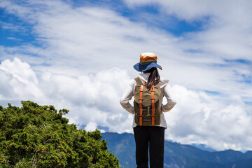 Canvas Print - Hiking woman stand on the top of the peak