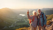 © Татьяна Прокопчук - Two happy active seniors having fun at the top of the mountain. Couple of mature people enjoying and having fun in vacations. Traveling  lifestyle