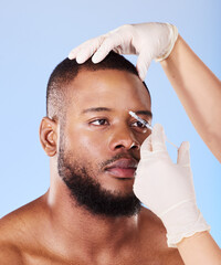 Wall Mural - Black man, plastic surgery and needle in studio for beauty, dermatology or face transformation by background. African patient, model or surgeon hands for skincare, syringe or eye filler for aesthetic