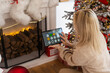 © Angelov - Modern home smart automation app on tablet display in woman hands at Christmas