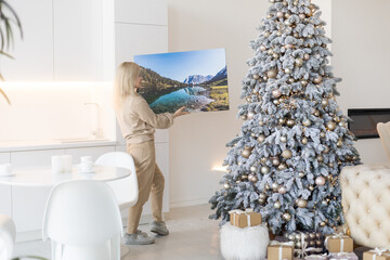 woman holding a photo canvas as a Christmas present