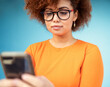© ChasingMagic/peopleimages.com - Woman, cellphone and mobile texting on blue background for social media, technology and network. Young female with smartphone technology in studio for connection, reading notification and website app